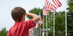 Boy saluting American flag